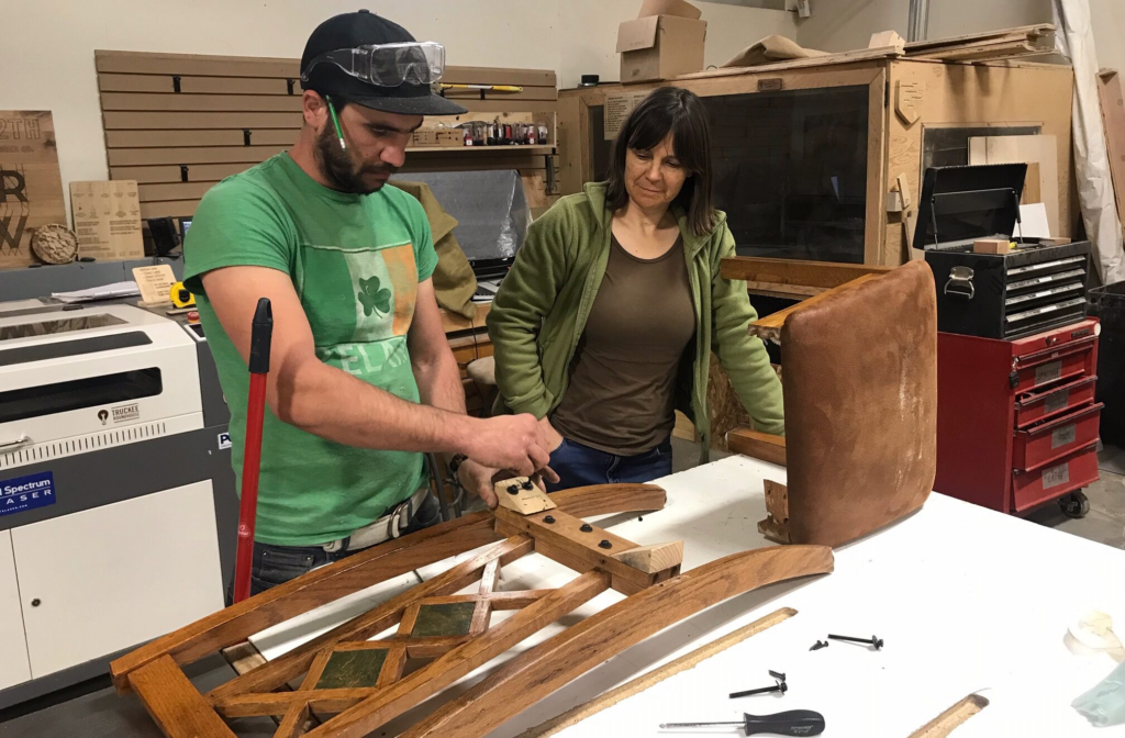 people working on a furniture repair at the fixit clinic.